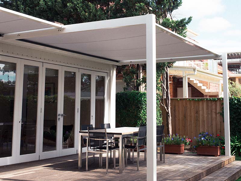 Patio awning on white timber frame for outdoor dining area