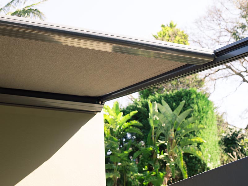 retractable patio awning over decks and balconies reduce the heat of the sun