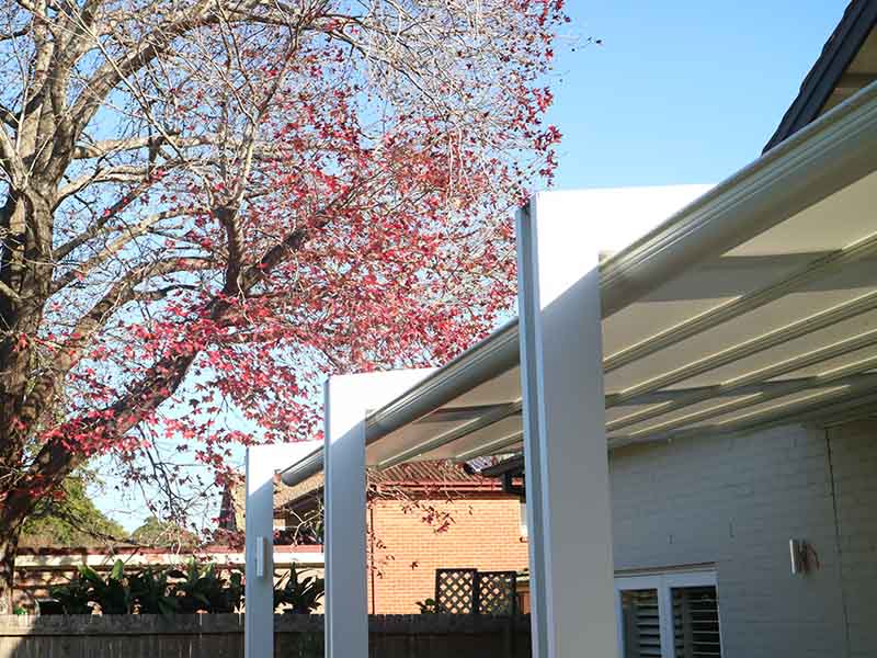 Retractble awning on pergola frame for sun and rain protection