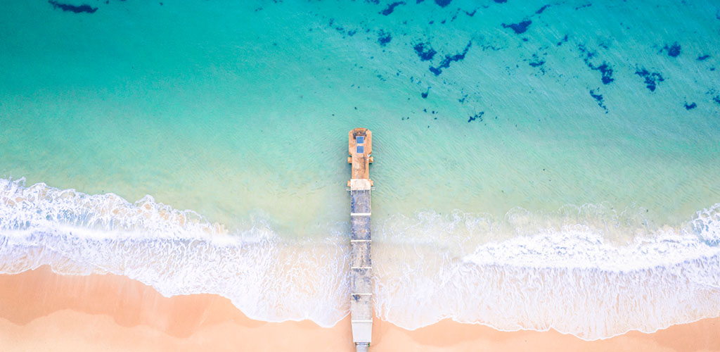 Collaroy storm water pipe amidst a electric blue ocean. Aalta supplies retractable awnings to the Collaroy Area and the Northern Beaches.