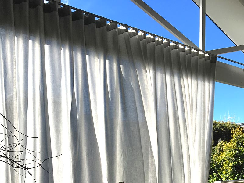 Outdoor curtains over deck for protection from the sun and privacy