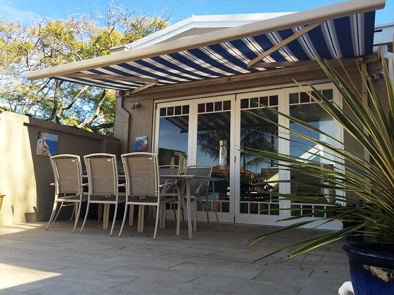 STriped retractable folding arm awning