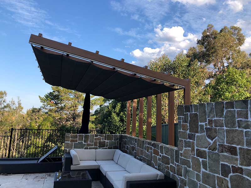 Retractable Shade Sail over comfy lounge