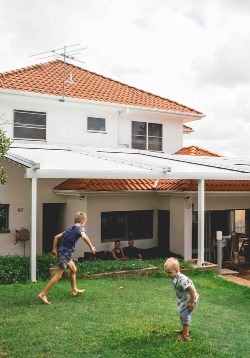 retractable roof extended over outdoor area with children playing outside