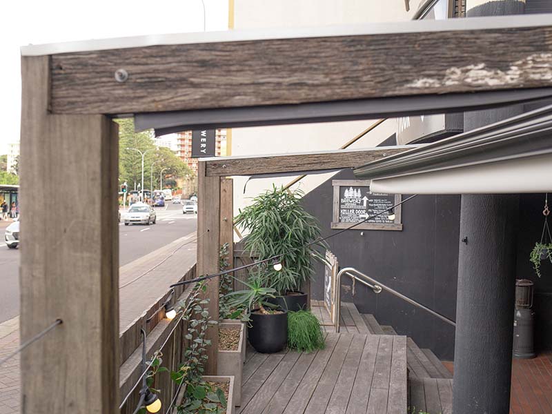 Custom-built retractable roof for manly 4 pines outdoor dining area